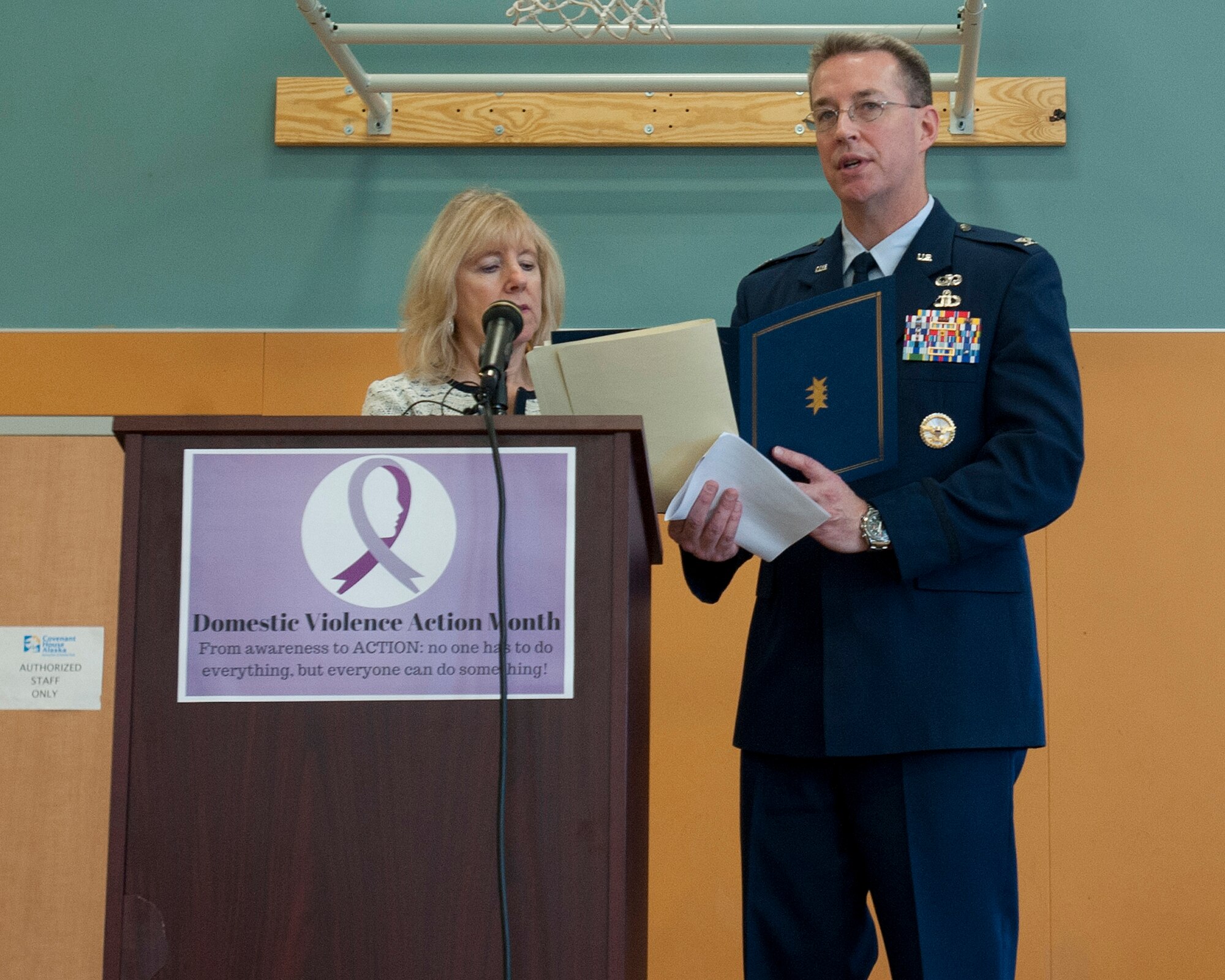 Air Force Col. Brian Bruckbauer and Melinda Freemon read the Joint Municipal and Joint Base Elmendorf-Richardson Proclamation together during the Domestic Violence Prevention Month opening ceremony on Oct. 1, 2014. Freemon is the director of the Department of Health and Human Services. Bruckbauer is the commander of the 673d Air Base Wing and JBER. (U.S. Air Force photo/Staff Sgt. Robert Barnett)