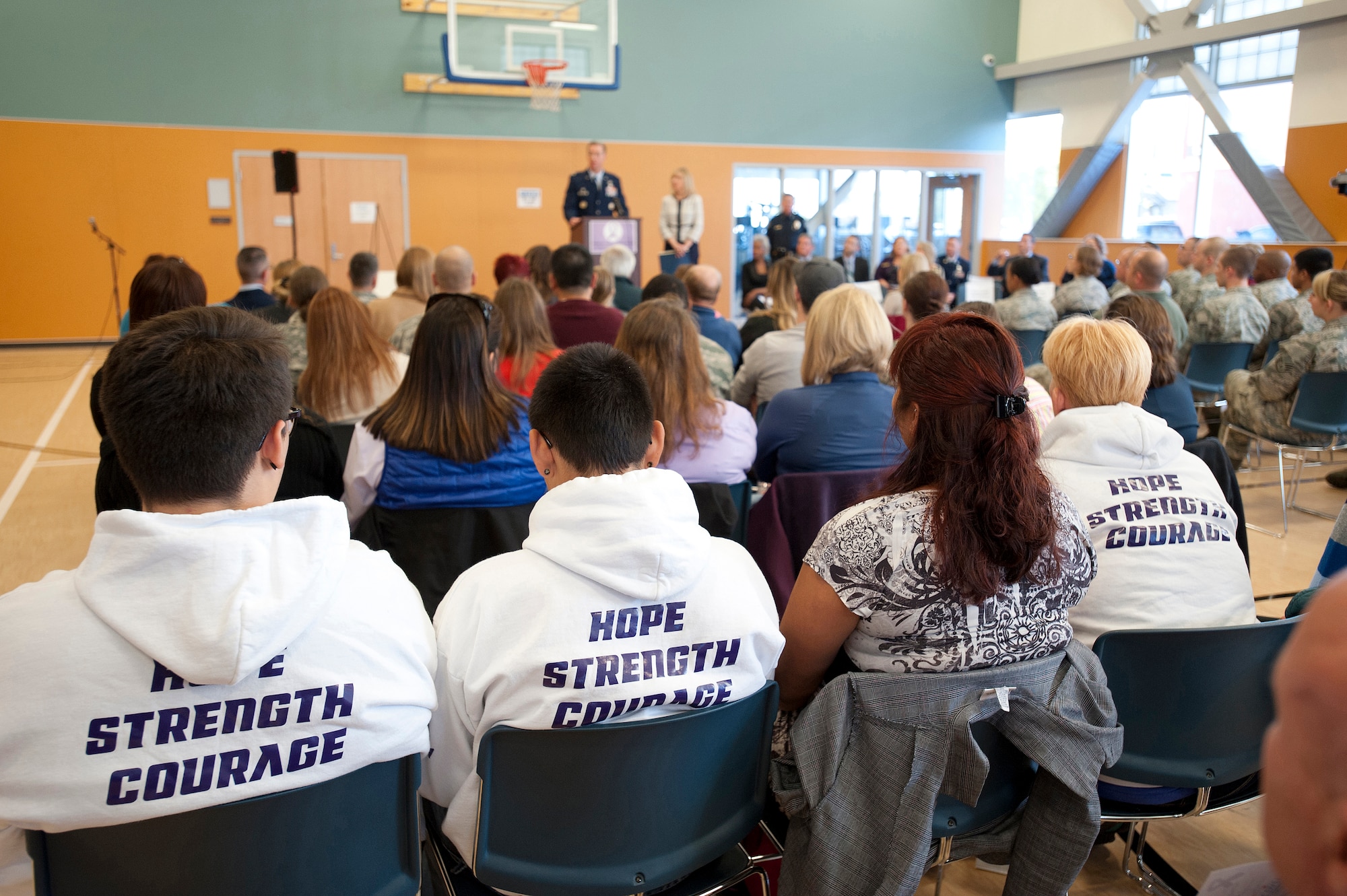 Members of Joint Base Elmendorf-Richardson and the Anchorage Community participate in a Domestic Violence Prevention Month opening ceremony Oct. 1, 2014 at the Covenant House in Anchorage, Alaska. Representatives from Anchorage social services, the Anchorage Police Department, Joint Base Elmendorf-Richardson, the Municipality of Anchorage mayor’s office, Sen. Mark Begich, a representative from the office of Alaska governor Sean Parnell and others from JBER and the Anchorage community participated in the event. Awards were presented to those making a positive impact against domestic violence, including Alaska the National Guard Master Sgt. Brian Neild intervened in an incident, stopping the violence. (U.S. Air Force photo/Staff Sgt. Robert Barnett)
