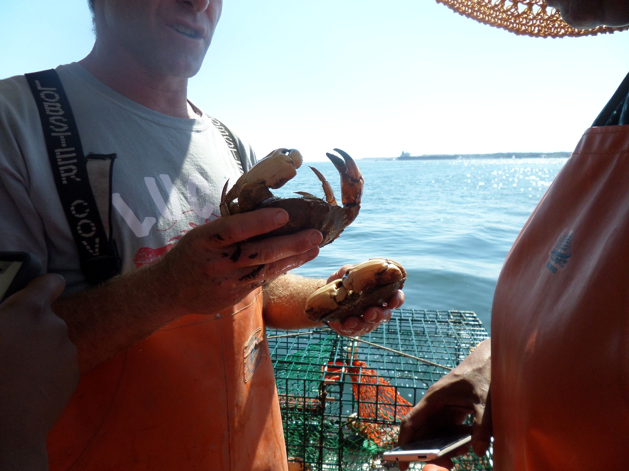 The captain of the Lucky Catch lobster boat removes Jonah crabs from traps during a Hanscom Junior Force Council lobstering trip to Portland, Maine, Sept. 27. Airmen had to chance to mix and mingle with other members from different offices on base while taking time out to learn about the state's fishing industry. (U.S. Air Force photo by Jeff Price)