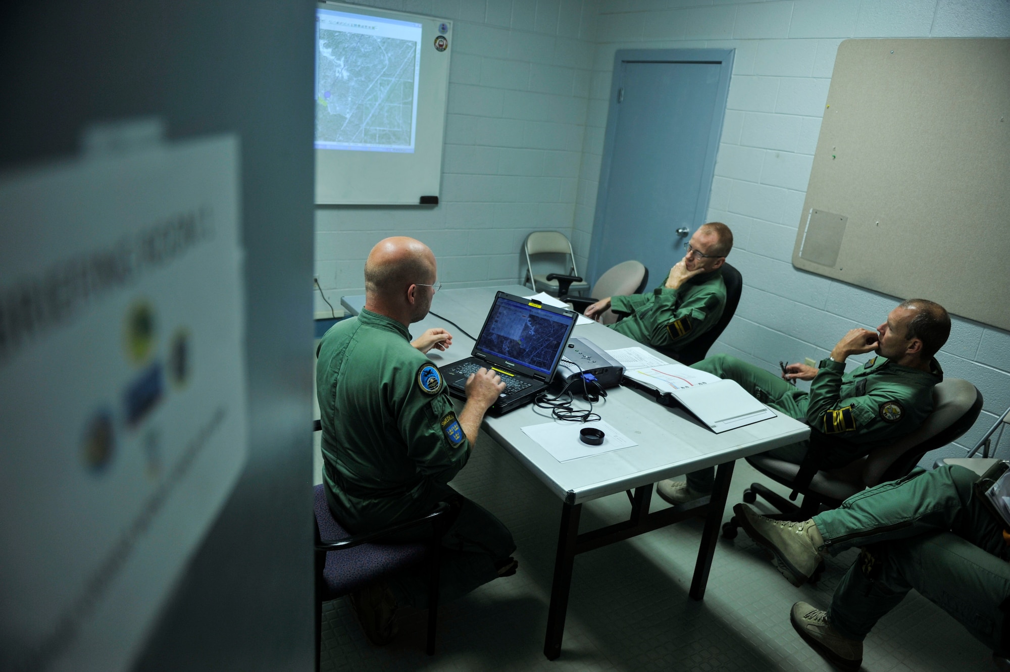Swedish Air Force aircrew members conduct an intelligence and tactics brief for GREEN FLAG Little Rock 14-10.5 Sept. 17, 2014, at Little Rock Air Force Base, Ark. Team Little Rock joined forces with their Swedish Air Force partners to support the Army in this exercise at Fort Polk, La. (U.S. Air Force photos by Senior Airman Regina Agoha)
