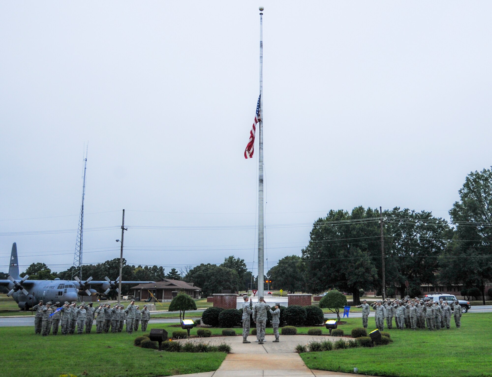 Airmen from the 19th Force Support Squadron salute the flag during Reveille Sept. 12, 2014, at Little Rock Air Force Base, Ark. One squadron from the base conducts Reveille each month to build unit morale and carry out a military tradition. (U.S. Air Force photo by Airman 1st Class Harry Brexel)