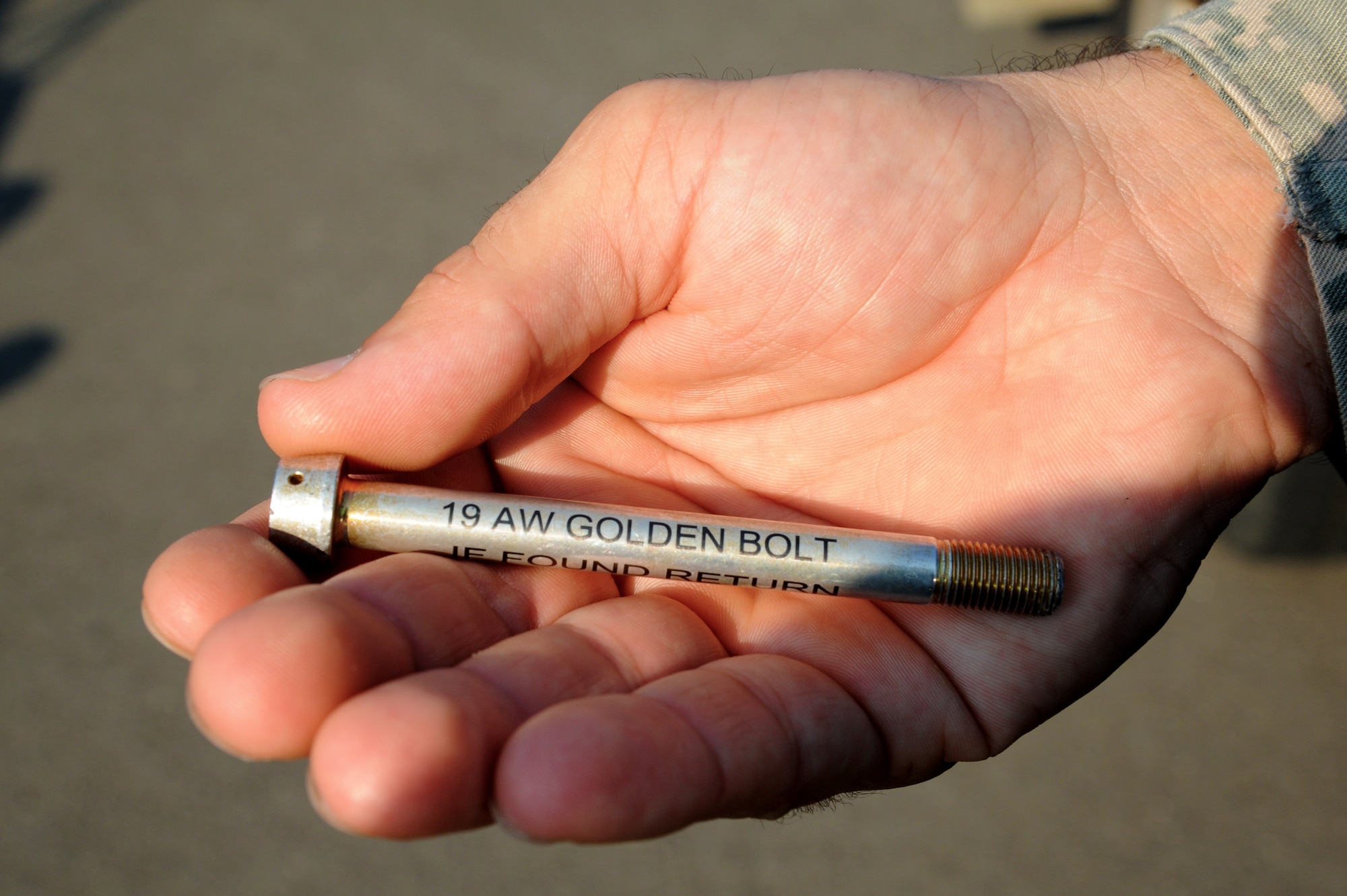 The Golden Bolt Program is an incentive for Airmen to stay vigilant while performing the foreign object debris walk. If an Airman finds the golden bolt during a walk, he or she receives a one-day pass from work among other recognition. (U.S. Air Force photo by Airman 1st Class Mercedes Muro) 