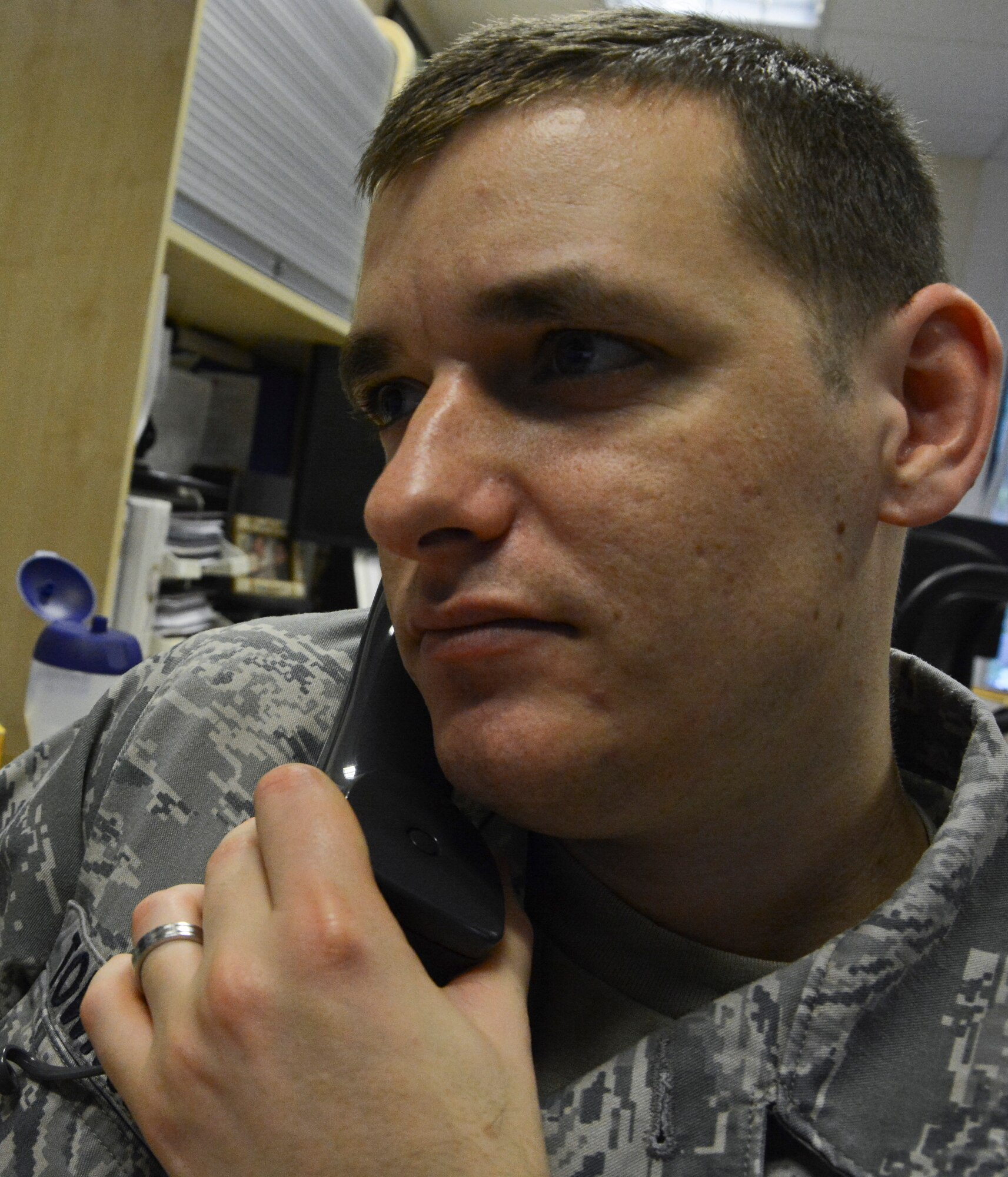 U. S. Air Force Staff Sgt. Shea Townsend, 100th Comptroller Squadron budget analyst journeyman from Whittier, Calif., talks on the phone Sept. 30, 2014, on RAF Mildenhall, England. Airmen from the 100th CPTS communicate with Airmen from the 48th Contracting Squadron on RAF Lakenheath, England, to ensure all funds are allocated for the fiscal year closeout. (U.S. Air Force photo/Staff Sgt. Micaiah Anthony/Released)