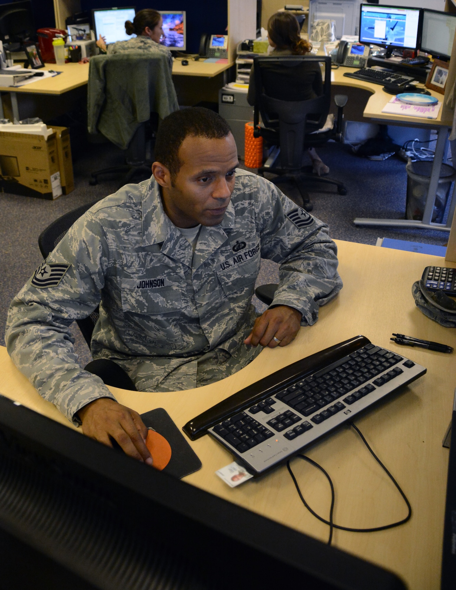 U.S. Air Force Tech Sgt. Adrian Johnson, 100th Comptroller Squadron financial analysis supervisor from Columbus, Ohio, works on a computer Sept. 30, 2014, on RAF Mildenhall, England. Airmen from the 100th CPTS worked past normal duty hours for the end of fiscal year 2014 closeout.  Any residual funding from purchases goes back into the allotted amount so it can be used toward other mission essential purchases. (U.S. Air Force photo/Staff Sgt. Micaiah Anthony/Released)