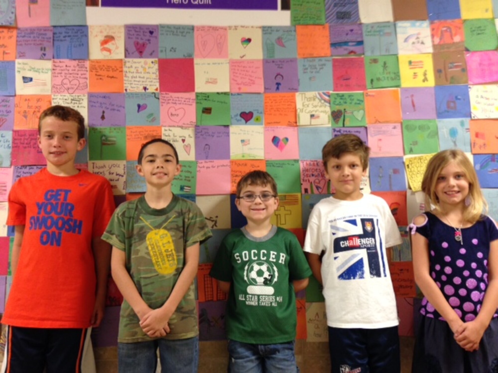 SAN ANGELO, Texas – Glenmore Elementary School students pose in front of their handmade “Hero Quilt” at Glenmore Elementary Sept. 25. The project was a part of a lesson about 9/11. (Courtesy photo)