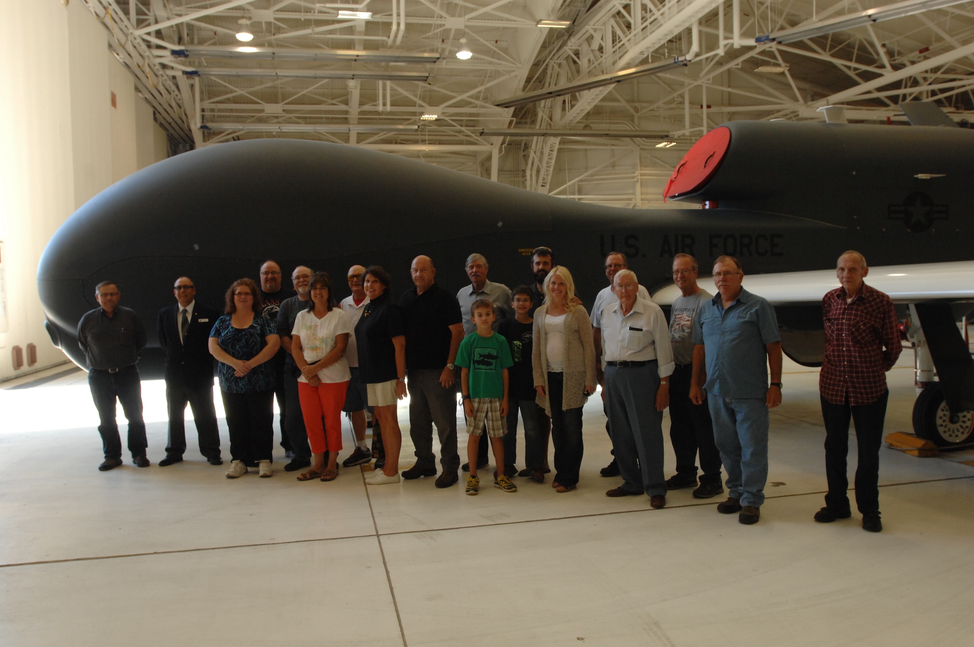 Military retirees and family members toured a 69th Reconnaissance Group hangar Sept. 27, 2014, to learn more about the RQ-4 Global Hawk Block 40. The tour was a rare opportunity for the group to see an unmanned aerial vehicle up close. (U.S. Air Force photo/Staff Sgt. Susan L. Davis)
