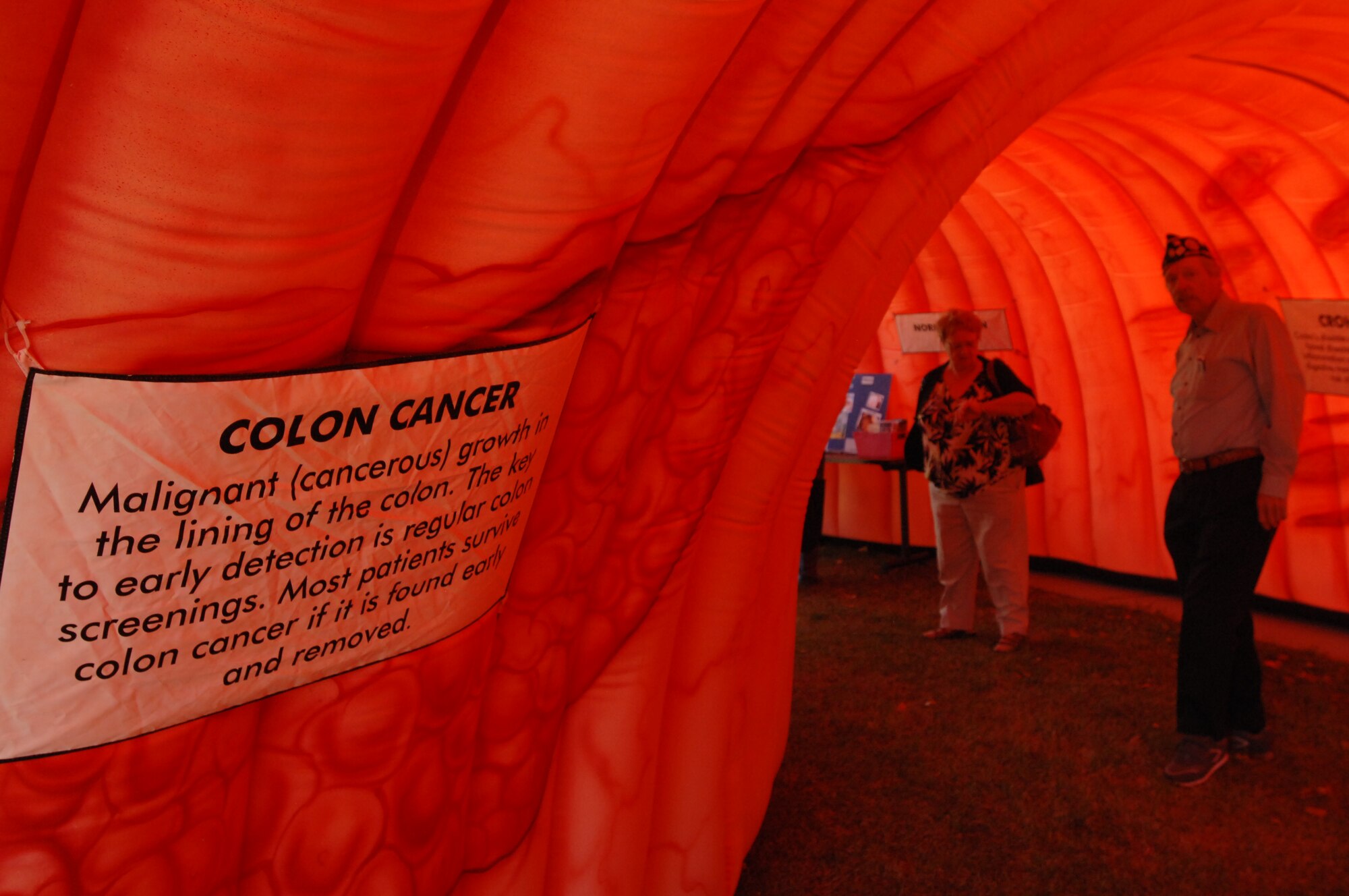 Military retirees visit a colon cancer display Sept. 27, 2014, on Grand Forks Air Force Base, N.D., to learn more about the disease and preventative measures. The display was a new addition to the annual event spearheaded in part by the 319th Medical Group. (U.S. Air Force photo/Staff Sgt. Susan L. Davis)