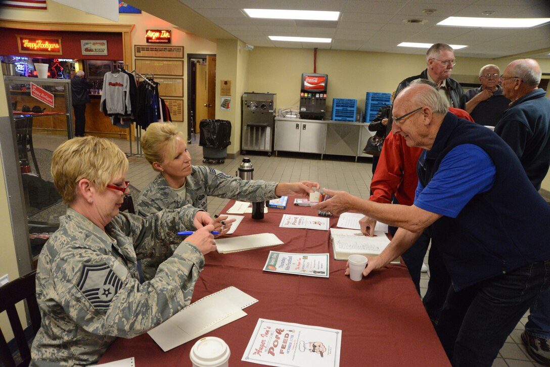 From left to right Senior Master Sgt. Susan Schroeder, of the 119th Communications Flight, and Chief Master Sgt. Leah Terry, of the 119th Force Support Squadron, hand out nametags to people entering the annual retiree breakfast hosted by the chief’s council at the North Dakota Air National Guard Base, Fargo, North Dakota, Oct. 1, 2014. Retired Chief Master Sgt. Jack Tietgens is first in line in this photo as he gets his nametag. Jack is instrumental in keeping the retired Happy Hooligans informed about retiree events. (U.S. Air National Guard photo by Senior Master Sgt. David H. Lipp/Released)