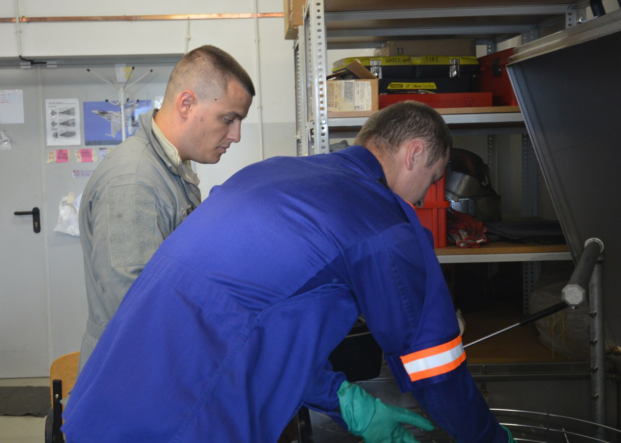 Staff Sgt. Troy Metivier, 31st Maintenance Squadron wheel and tire shop, observes as Polish air force Starszy Kapral (Corpral) Kamil Zawadka mechanic removes baring from the cleaner at Lask Air Base, Poland, Sept. 22, 2014. The Airmen of the wheel and tire shop ensure the multi-million dollar F-16s are able to taxi, take-off and land safely. Seven F-16 Fighting Falcons from the 510th Fighter Squadron and approximately 150 support personnel from the 31st Fighter Wing at Aviano Air Base, Italy, arrived at the U.S. Air Force Aviation Detachment to participate in bilateral training with Poland. (U.S. Air Force photo/Tech. Sgt. Eric Donner)  