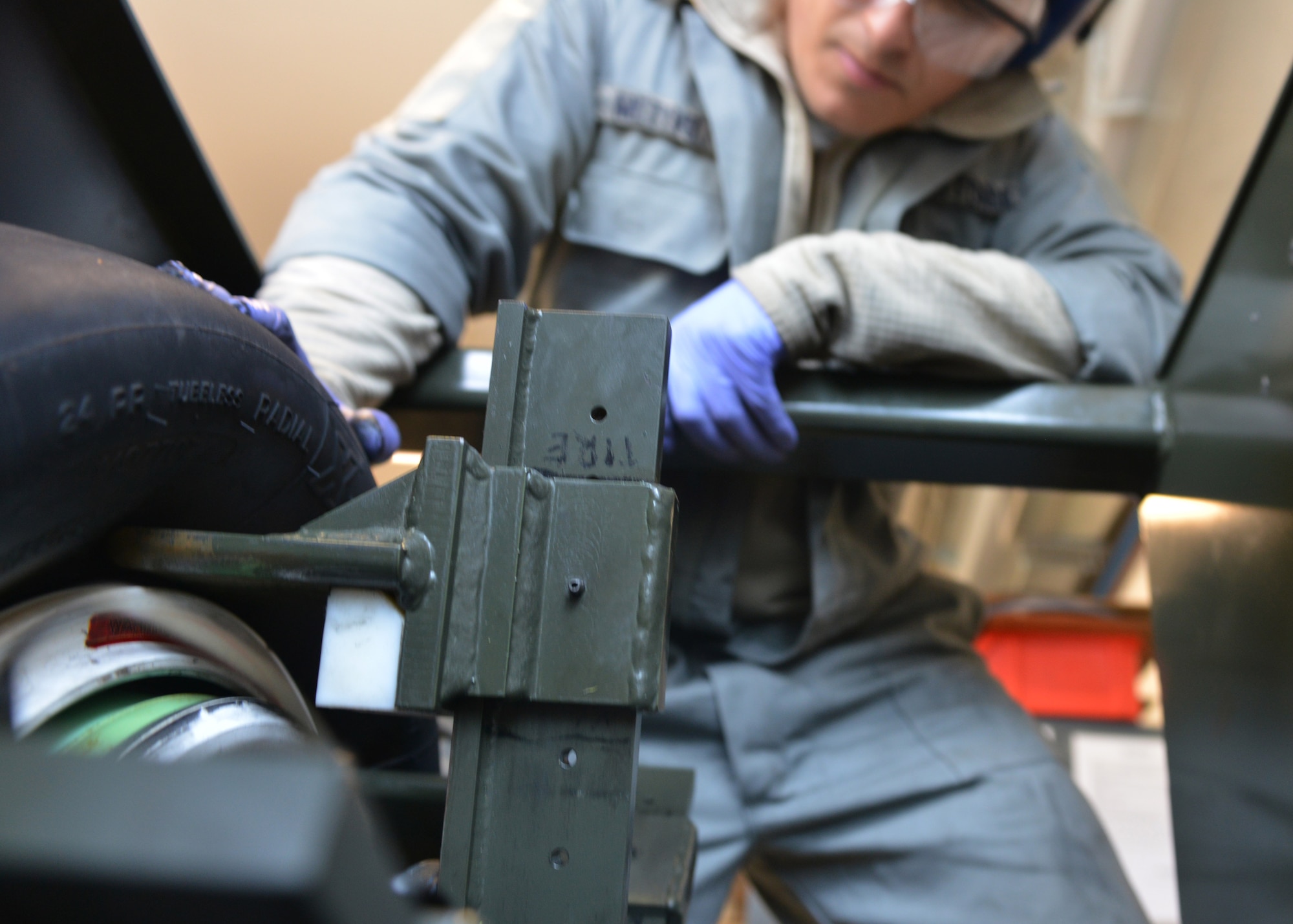 Staff Sgt. Troy Metivier, 31st Maintenance Squadron wheel and tire shop technician, removes a tire from the wheel at Lask Air Base, Poland, Sept. 22, 2014. The Airmen of the wheel and tire shop ensure the multi-million dollar F-16 Fighting Falcons are able to taxi, take-off and land safely. Seven F-16 from the 510th Fighter Squadron and approximately 150 support personnel from the 31st Fighter Wing at Aviano Air Base, Italy, arrived at the U.S. Air Force Aviation Detachment to participate in bilateral training with Poland. (U.S. Air Force photo/Tech. Sgt. Eric Donner)