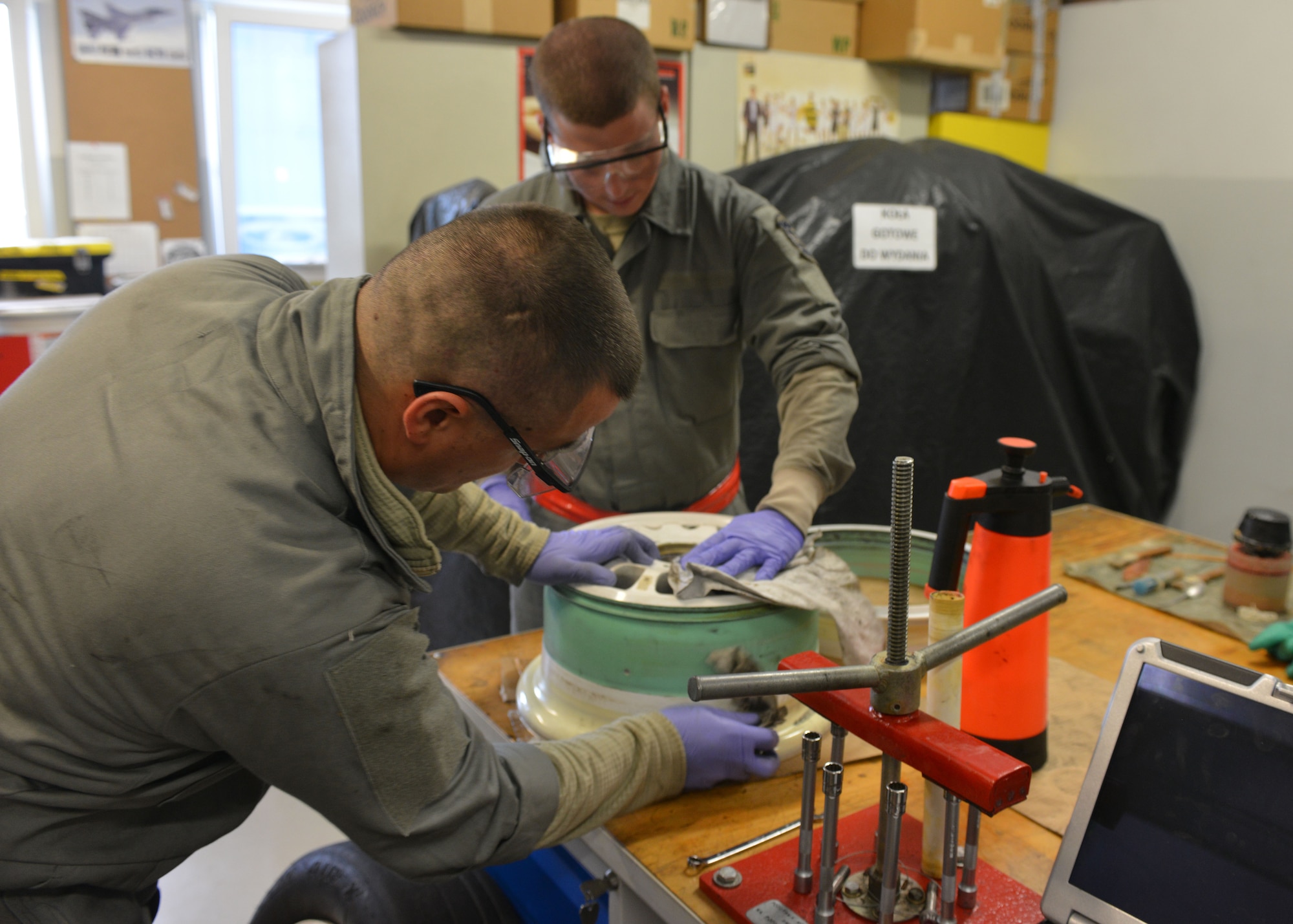 (left) Staff Sgt. Troy Metivier and Senior Airmen Taylor Hendricks 31st Mainteance squadron wheel and tire shop technicians, hand clean an F-16 Fighting Falcon’s main wheel before inspecting it for any abnormalities at Lask Air Base, Poland, Sept. 22, 2014. The Airmen of the wheel and tire shop ensure the multi-million dollar F-16s are able to taxi, take-off and land safely. Seven F-16 from the 510th Fighter Squadron and approximately 150 support personnel from the 31st Fighter Wing at Aviano Air Base, Italy, arrived at the U.S. Air Force Aviation Detachment to participate in bilateral training with Poland. (U.S. Air Force photo/Tech. Sgt. Eric Donner)
