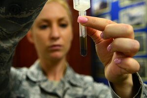 U.S. Air Force Senior Airman Kelly Berger, 633rd Civil Engineer Squadron pest management technician, extracts a sample of dissolved mosquitoes for disease testing in the 633rd CES entomology shop at Langley Air Force Base, Va., Sep. 30, 2014. After capturing various mosquito species in traps, the entomology shop freezes them, separates each species and creates a solution from them to test for disease. (U.S. Air Force photo by Airman 1st Class Devin Scott Michaels/Released)