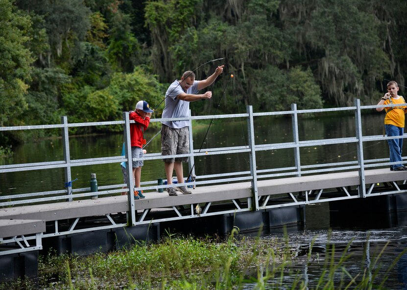 Corbin Delk and his stepfather U.S. Air Force Staff Sgt. Andrew Abel catch a fish during the Youth Fishing Rodeo Sept. 27, 2014, at Grassy Pond in Lake Park, Ga. Children and their families had the choice of fishing from the docks at Grassy Pond or on boats. (U.S. Air Force photo by Senior Airman Sandra Marrero/Released)
