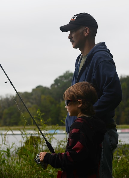 Seamus Boyd and father Jesse Boyd fish during the Youth Fishing Rodeo Sept. 27, 2014, at Grassy Pond in Lake Park, Ga. Moody Air Force Base collaborated with the Lowndes County Parks and Recreation Authority to host this event. (U.S. Air Force photo by Senior Airman Sandra Marrero/Released)
