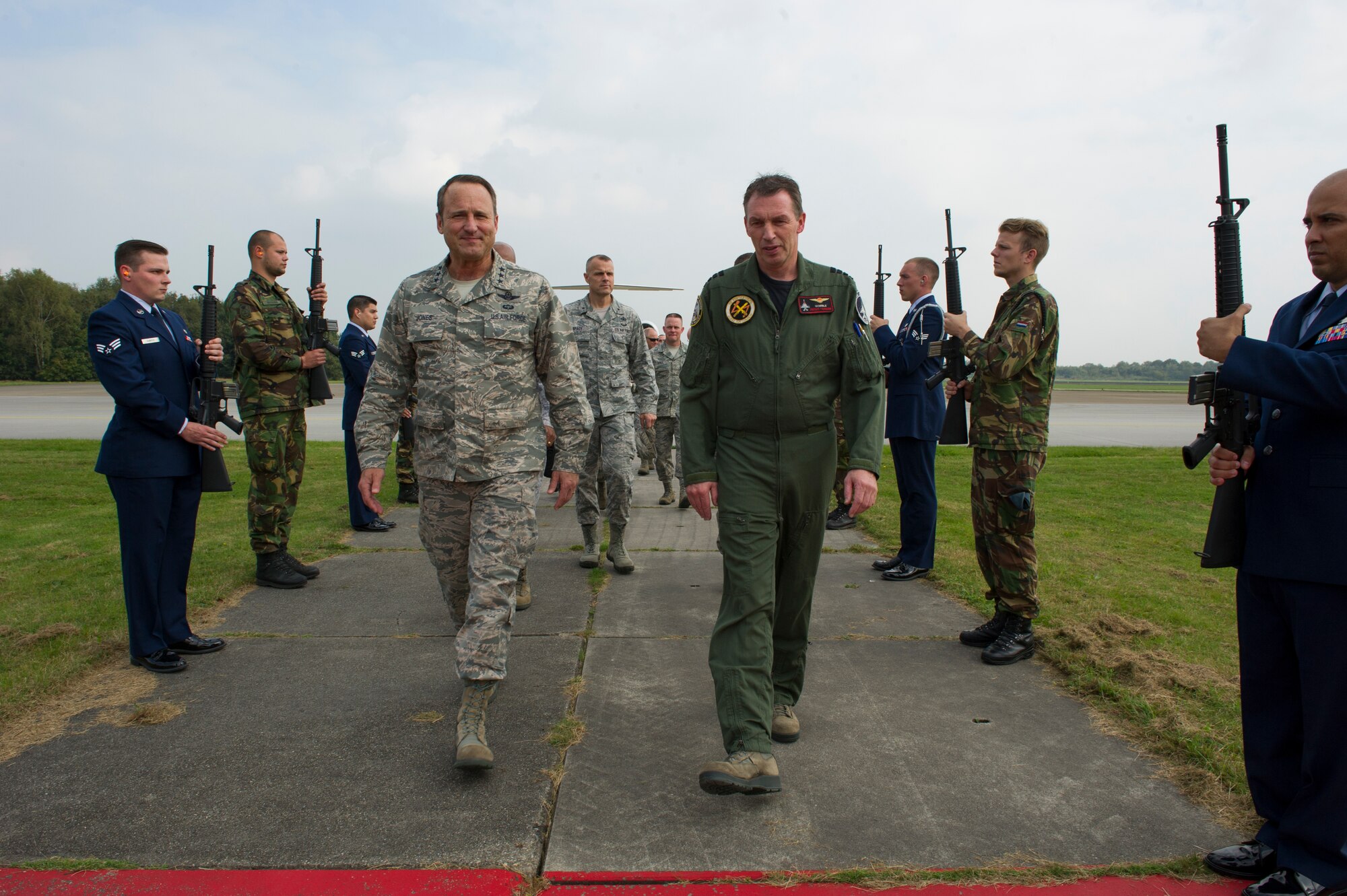 VOKEL AIR BASE, Netherlands -- Lt. Gen. Tom Jones, U.S. Air Forces in Europe and Air Forces Africa vice commander, and Royal Netherlands air force Colonel Peter Tankink, 1st Fighter Wing commander, walk through an honor guard cordon as the general arrives at Vokel Air Base, Netherlands, Sept. 30, 2014. The vice commander and other senior members of the USAFE-AFAFRICA staff visited munitions support squadrons at three locations to receive mission briefs and updates on current challenges at the locations. (U.S. Air Force photo by/Tech. Sgt. Benjamin Wilson)