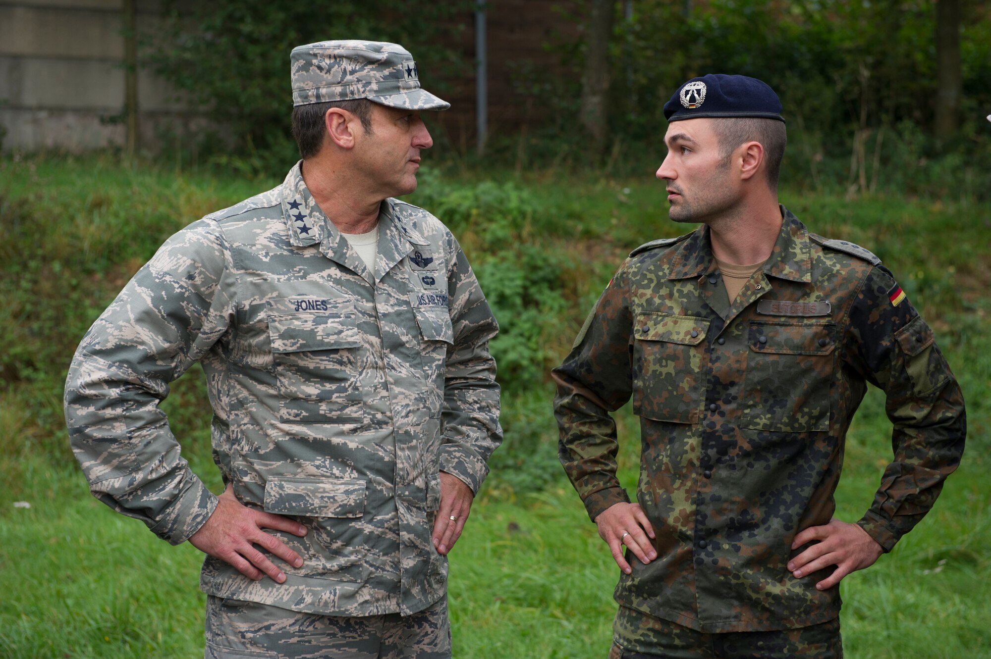 BUECHEL AIR BASE, Germany -- Lt. Gen. Tom Jones, right, U.S. Air Forces in Europe and Air Forces Africa vice commander, speaks with German Capt. Sebastian Sutorius during his visit to the 702nd Munitions Support Squadron at Buechel Air Base, Germany, Sept. 30, 2014. The German and U.S. Air Forces work closely together at the base to ensure the success of NATO missions. (U.S. Air Force photo/Tech. Sgt. Benjamin Wilson)
