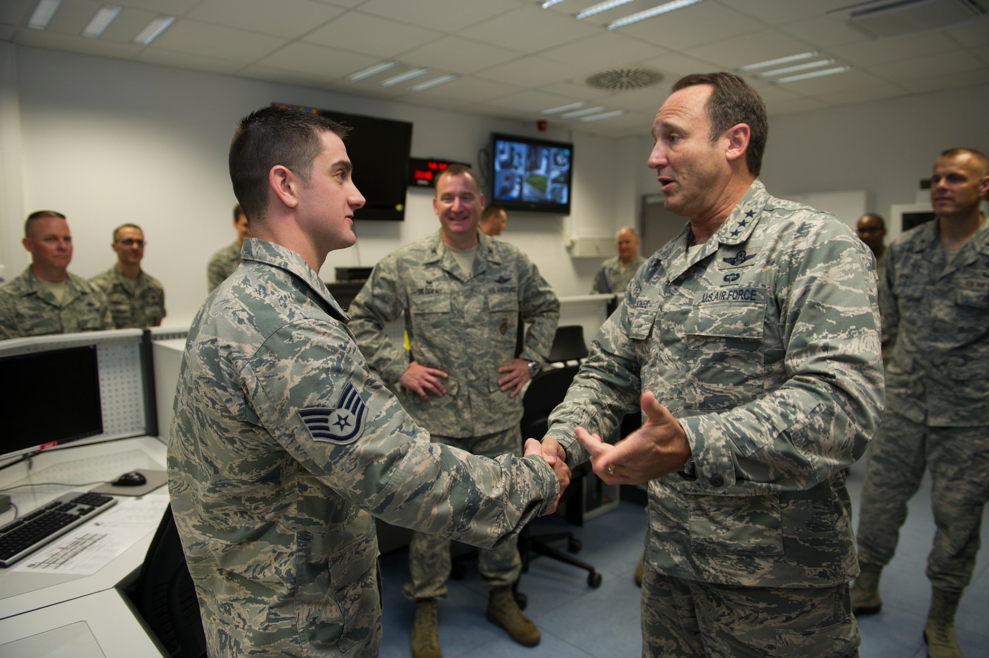 BUECHEL AIR BASE, Germany -- Lt. Gen. Tom Jones, U.S. Air Forces in Europe and Air Forces Africa vice commander, coins Staff Sgt. Stephen Wagner, 702nd Munitions Support Squadron command post, for his outstanding contribution to the mission at Buechel Air Base, Germany, Sept. 30, 2014. The command post at the 702nd MUNSS has been awarded outstanding command post of the year three out of the last four years. (U.S. Air Force photo/Tech. Sgt. Benjamin Wilson) 