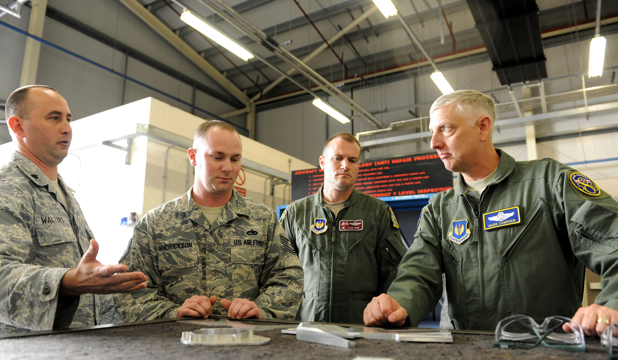 U.S. Air Force Brig. Gen. Mark Camerer, right, U.S. Air Forces in Europe and U.S. Air Forces Africa director of plans, programs and analyses, learns about metals technology in the 100th Maintenance Group Sept. 30, 2014, on RAF Mildenhall, England. During Camerer’s first visit to RAF Mildenhall since assuming his current position, he toured several facilities and met a multitude of Airmen to better understand the base’s requirements and mission capabilities. (U.S. Air Force photo/Senior Airman Kate Maurer/Released) 