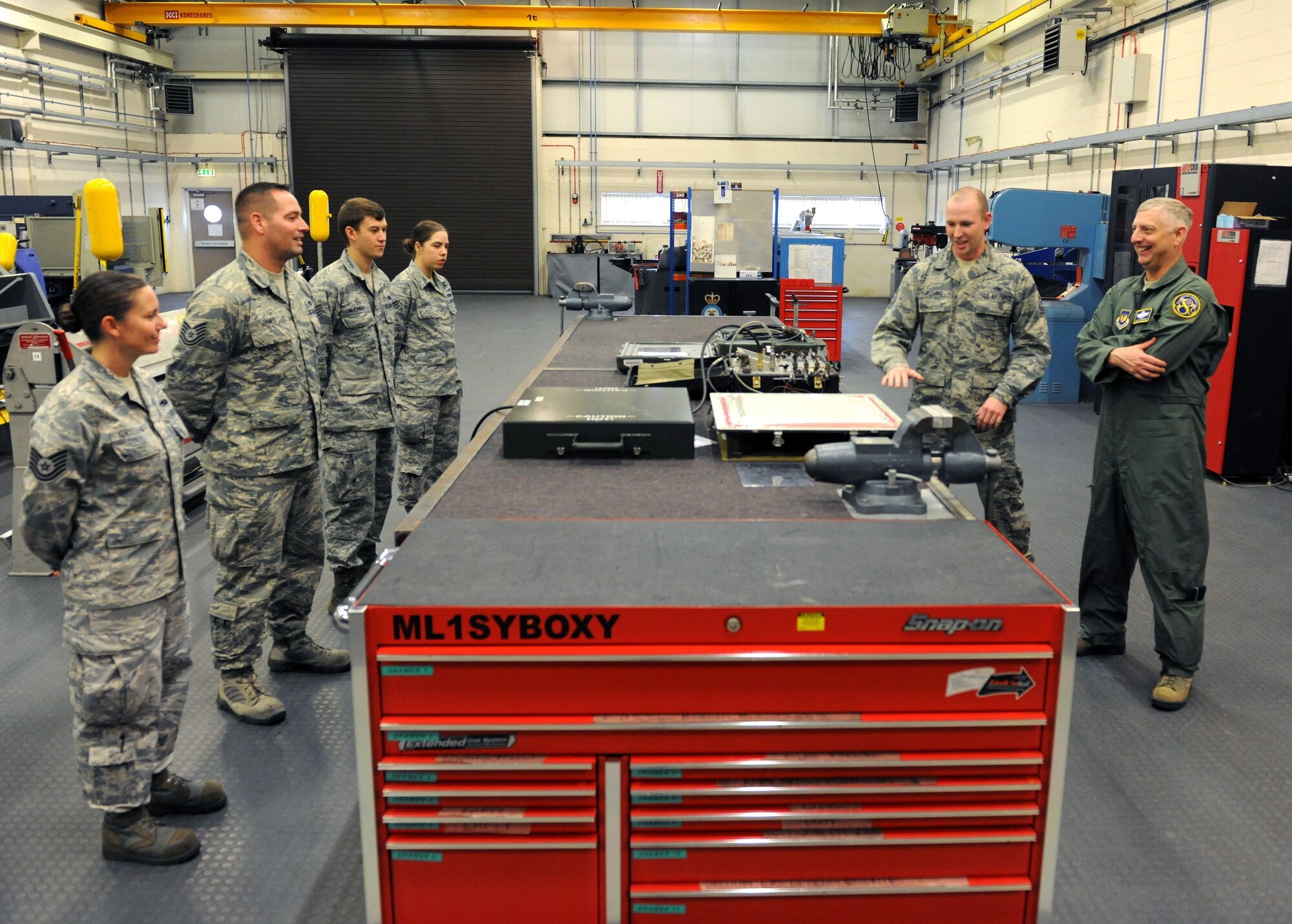 Airmen from the 100th Maintenance Squadron brief U.S. Air Force Brig. Gen. Mark Camerer, right, U.S. Air Forces in Europe and U.S. Air Forces Africa director of plans, programs and analyses, about KC-135 Stratotanker aircraft maintenance Sept. 30, 2014, on RAF Mildenhall, England. During Camerer’s first visit to RAF Mildenhall since assuming his current position, he toured several facilities and met a multitude of Airmen to better understand the base’s requirements and mission capabilities. (U.S. Air Force photo/Senior Airman Kate Maurer/Released) 