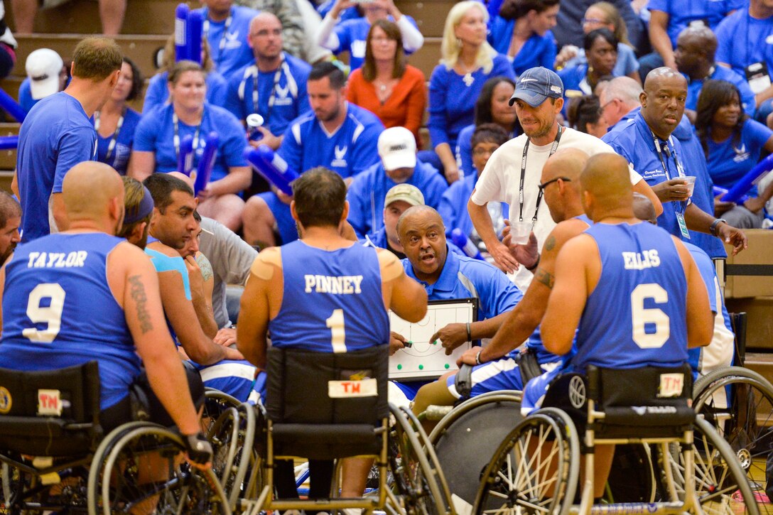 Air Force coach Willie Jackson discusses strategy with his team during a timeout as the Air Force faced the Navy in a wheelchair basketball game at the Warrior Games in Colorado Springs, Colo., Sept. 29, 2014.