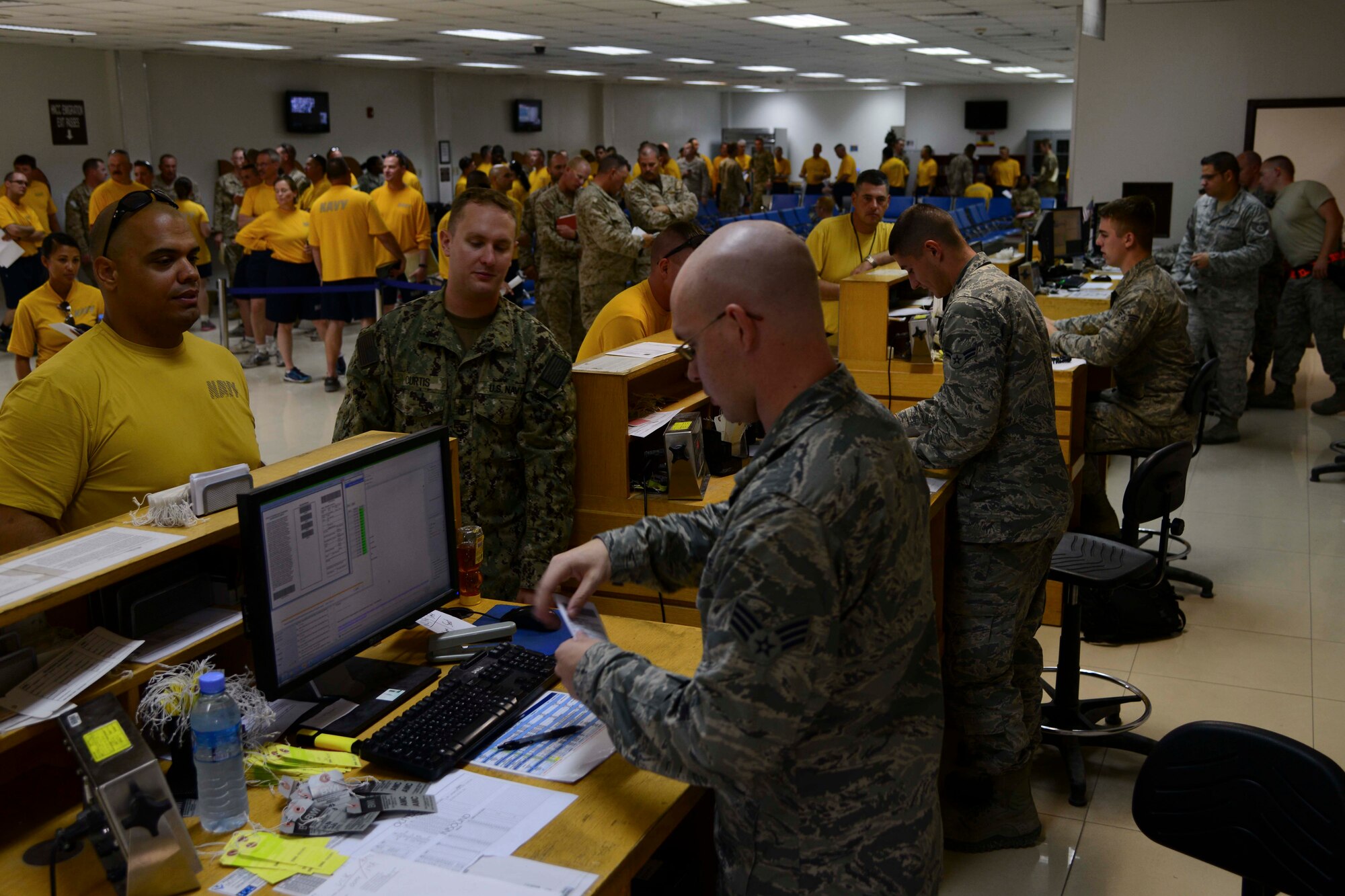 Service members check in for seat assignments at Al Udeid Air Base, Qatar, Oct. 1, 2014. The 8th Expeditionary Air Mobility Squadron’s passenger terminal averages more than 85,000 passengers annually. (U.S. Air Force photo by Staff Sgt. Ciara Wymbs)