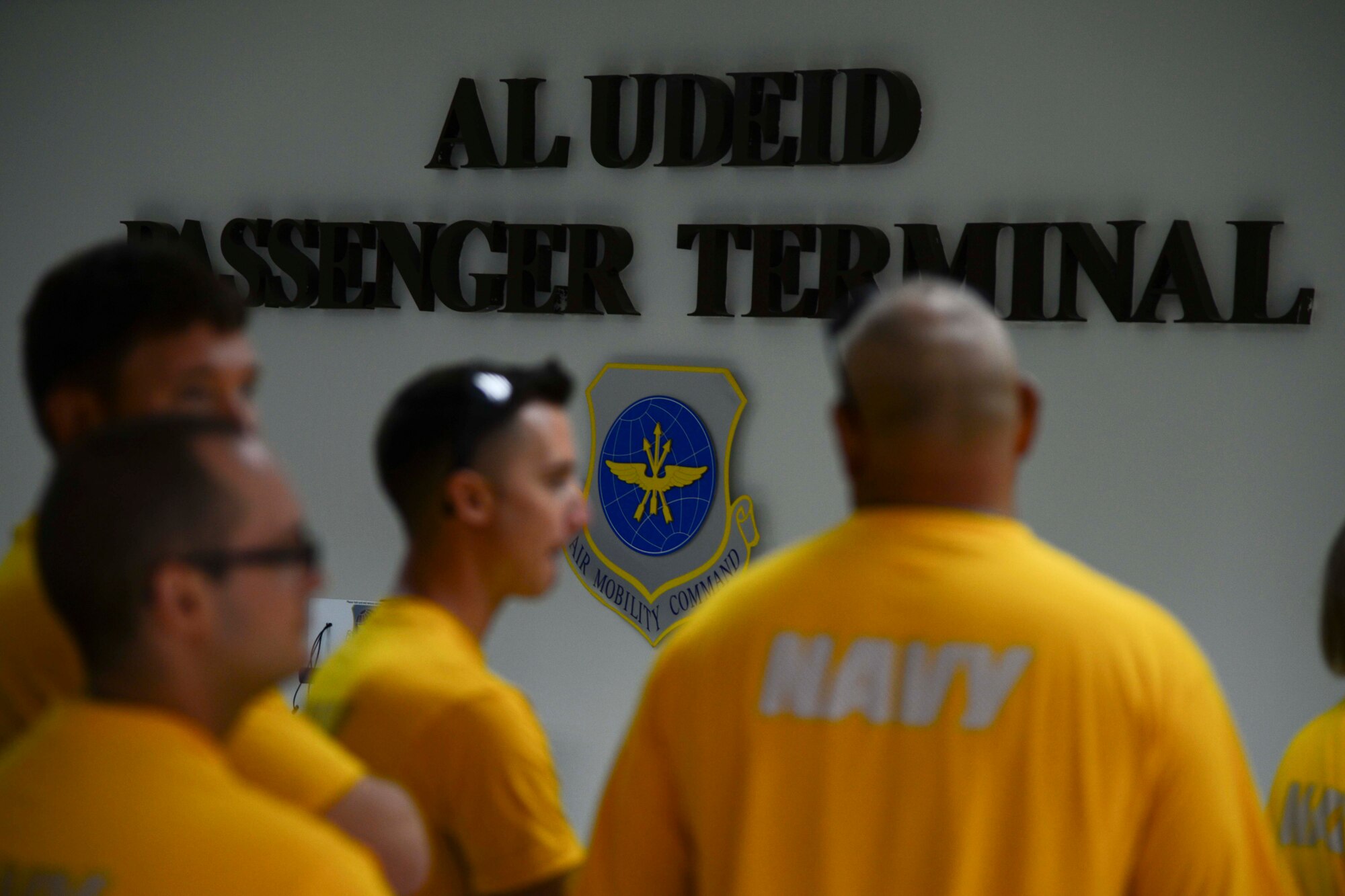 U.S. Navy Sailors wait in line for processing at Al Udeid Air Base, Qatar, Oct. 1, 2014. The 8th Expeditionary Air Mobility Squadron’s passenger terminal averages more than 85,000 passengers with 3,200 tons of accompanying baggage and nearly 1,000 distinguished visitors annually. (U.S. Air Force photo by Staff Sgt. Ciara Wymbs)