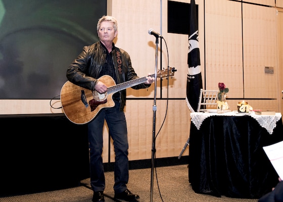 Recording artist Jeff Senour performs his song, “You Will Not Be Forgotten,” at the Legacy of Valor event at DIA Headquarters Sept. 29.
