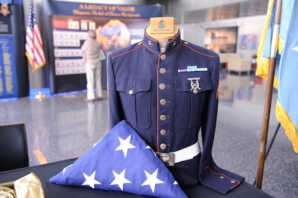 A historic Marine Corps uniform with the Medal of Honor ribbon is prominently showcased with U.S. flag as part of the Hispanic Medal of Honor Society’s Legacy of Valor exhibit, on display at DIA Headquarters this week in celebration of Hispanic Heritage Month.  Photo by Army Lt. Col. Al Stout, OCC-2