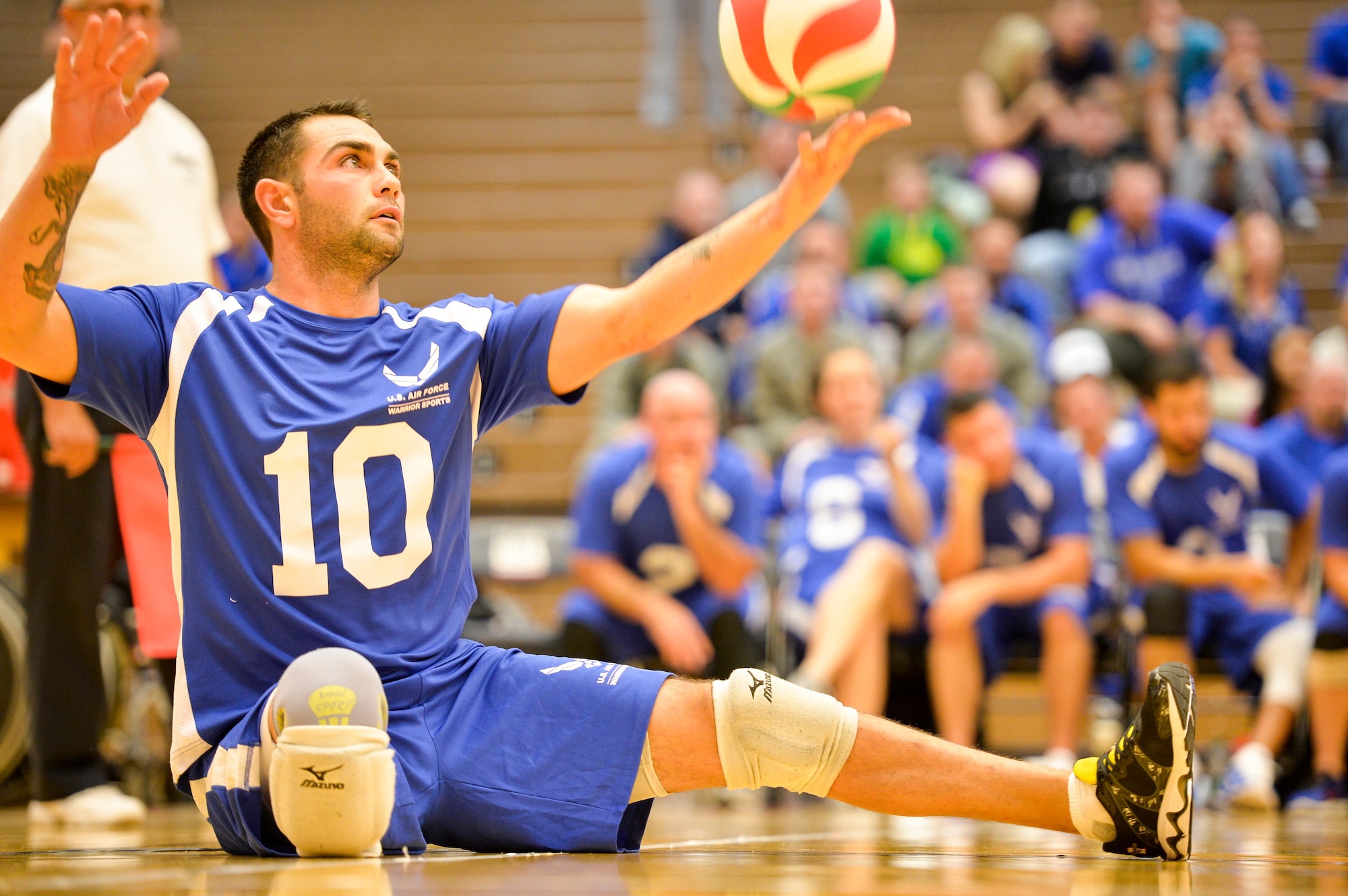 Retired Air Force Staff Sgt. Nicholas Dadgostar serves the ball during the 2014 Warrior Games sitting volleyball bronze medal match between the Air Force and the Army Oct. 1, 2014, at the U.S. Olympic Training Center in Colorado Springs, Colo. The Army beat the Air Force in two sets, 25-20, 25-19. (U.S. Air Force photo/Staff Sgt. Devon Suits)