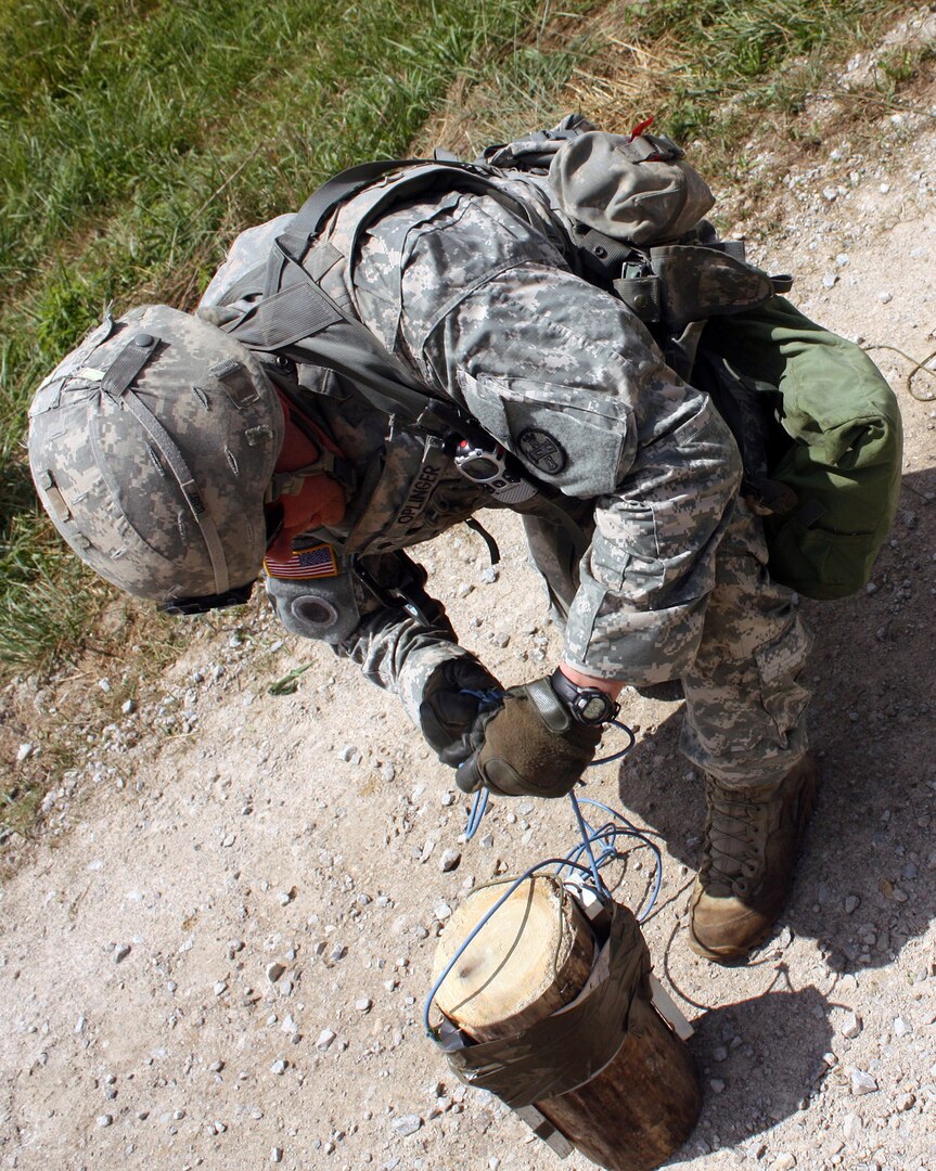 A Soldier with the Ohio Army National Guard’s 811th Engineer Company (Sapper) works to prepare a simulated shape charge during a training exercise, July 24, 2014, at Camp Atterbury, Ind. The 811th spent its two-week annual training period being assessed on its mission readiness by evaluators from First Army, the results of which help determine the 811th’s ability to be utilized by the Army if a mission need should arise. 