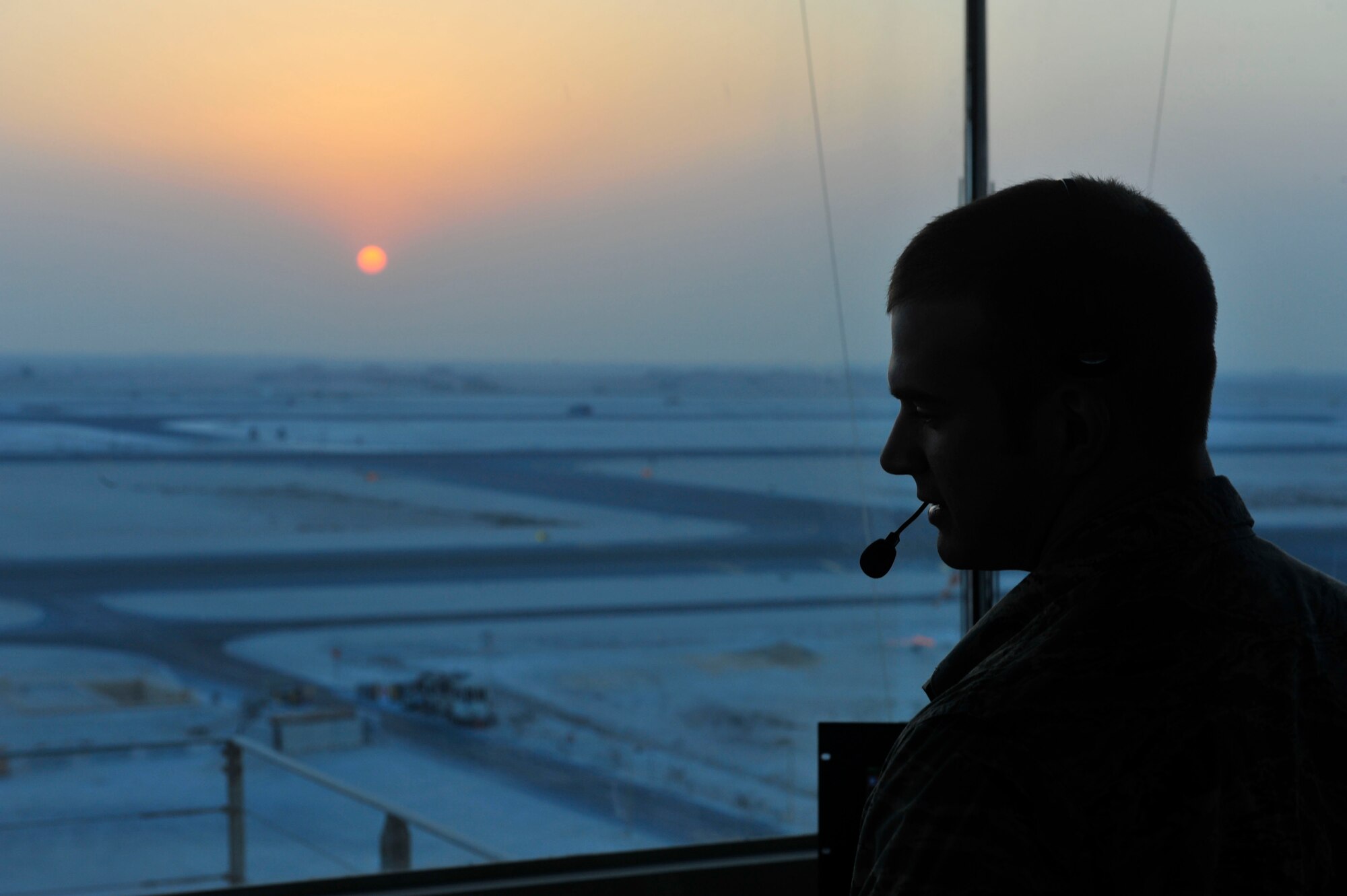 U.S. Air Force Staff Sgt. Richard Erler, 379th Expeditionary Operations Support Squadron air traffic control craftsman, talks on the radio at Al Udeid Air Base, Qatar, Sept. 24, 2014. Erler is deployed from the 55th Operations Support Squadron at Offutt Air Force Base, Nebraska. His hometown is St. Louis, Missouri. (U.S. Air Force photo by Senior Airman Colin Cates) 