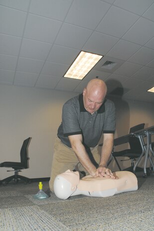 Bryan Thorson, Installation and Environmental Division, Marine Corps Logistics Base Albany, performs cardiopulmonary resuscitation on a simulated victim in cardiac arrest, recently. The class was hosted by the Marine Corps Fire Department.
