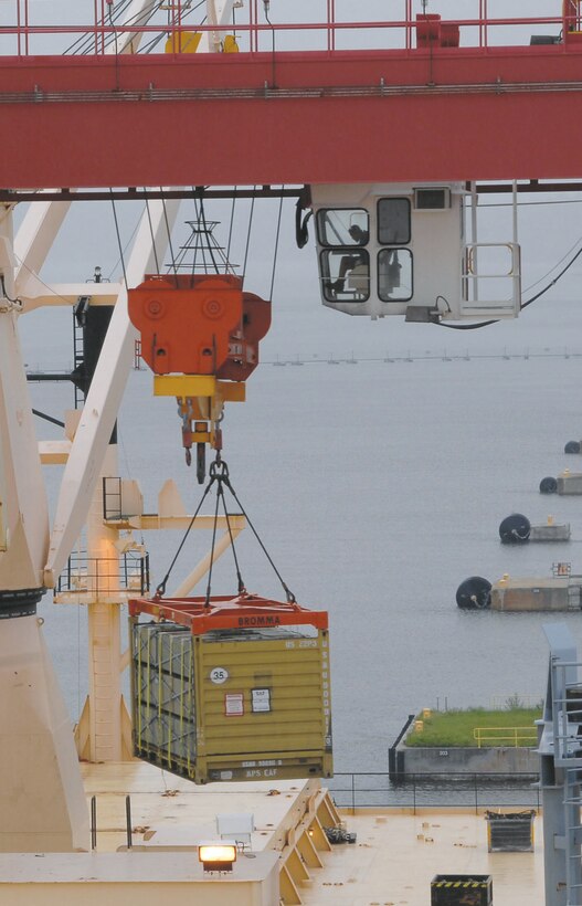 Simeon Crews, crane operator, Blount Island Command, Jacksonville, Fla., moves a container using the giant gantry crane named “Big Red” during a backload operation on a maritime prepositioning vessel, Sept. 23.