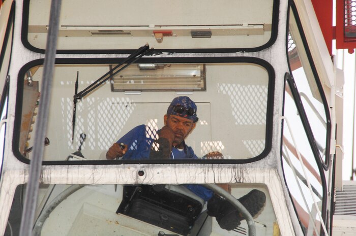 Simeon Crews, crane operator, Blount Island Command, Jacksonville, Fla., operates the giant gantry crane named “Big Red” during a backload operation on a maritime prepositioning vessel, Sept. 23.