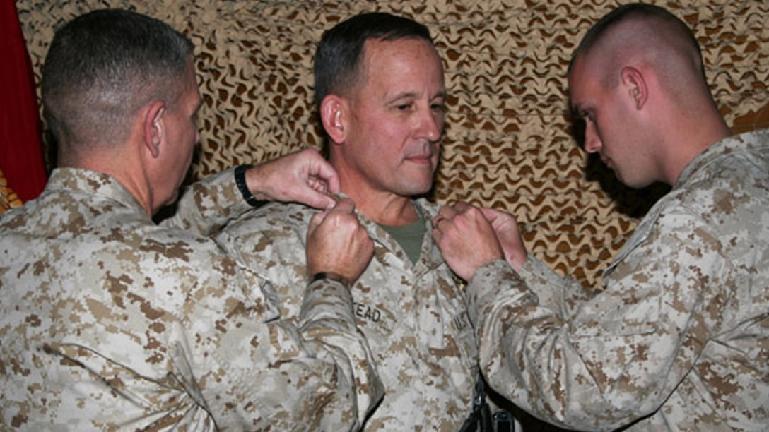 Then Brig. Gen. Milstead, center, is pinned on his rank during a promotion ceremony during a deployment in Iraq as commander of 2nd Marine Aircraft Wing in 2005. 