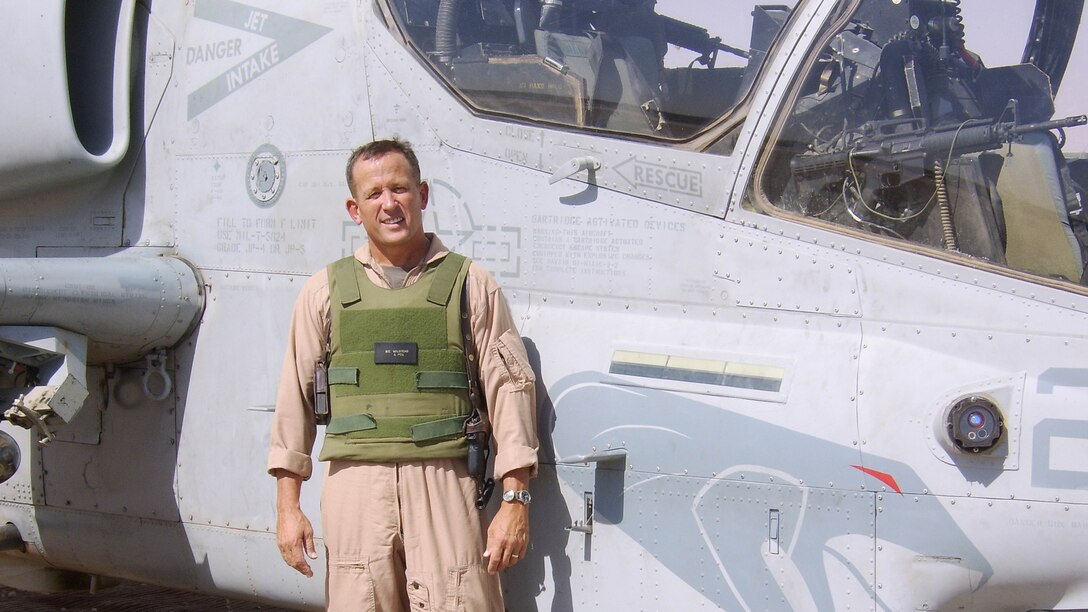 Lieutenant Gen. Robert E. Milstead Jr. poses for a photo in front of an AH-1 Cobra Helicopter. Milstead's forty year career in the Marine Corps recently came to a close. 