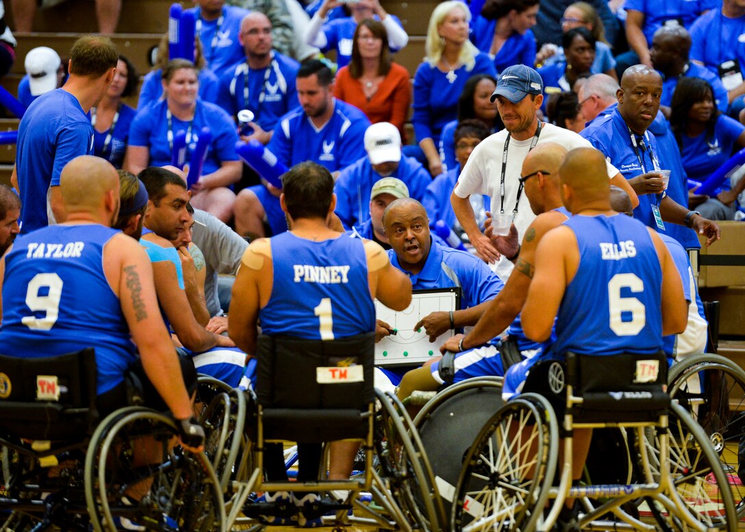 Coach Willie Jackson goes over the next play during an Air Force timeout in their game against Navy Sept. 29, 2014, during the 2014 Warrior Games at the U.S. Olympic Training Center in Colorado Springs, Colo. The Air Force lost 38-19. (U.S Air Force photo/Staff Sgt. Devon Suits)