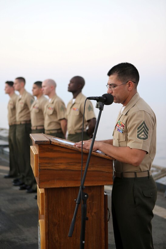 Staff Sgt. Adam Rivas, an assault amphibious vehicle crew chief with Echo Company, Battalion Landing Team 2nd Battalion, 1st Marines, 11th Marine Expeditionary Unit (MEU), and the acting director for corporal’s course aboard the USS Comstock (LSD 45), narrates the course’s graduation ceremony, Sept. 30. The 11th MEU is a forward-deployed, flexible sea-based Marine Air-Ground Task Force embarked with the Makin Island Amphibious Ready Group in the U.S. 5th Fleet area of responsibility. (U.S. Marine Corps photo by Sgt. Melissa Wenger/ Released)