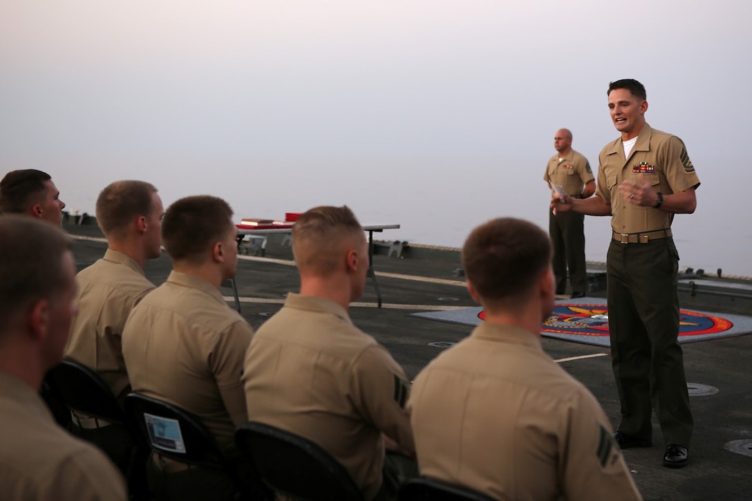 Guest of Honor Gunnery Sgt. Terry Weidman, company gunnery sergeant, Echo Company, Battalion Landing Team 2nd Battalion, 1st Marines, 11th Marine Expeditionary Unit (MEU),addresses graduates of the corporal’s course aboard the USS Comstock (LSD 45), Sept. 30. The 11th MEU is a forward-deployed, flexible sea-based Marine Air-Ground Task Force embarked with the Makin Island Amphibious Ready Group in the U.S. 5th Fleet area of responsibility. (U.S. Marine Corps photo by Sgt. Melissa Wenger/ Released)