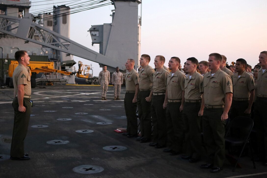 Corporals with the 11th Marine Expeditionary Unit (MEU) recite the noncommissioned officer’s creed during a corporal’s course graduation ceremony aboard the USS Comstock (LSD 45), Sept. 30. The 11th MEU is a forward-deployed, flexible sea-based Marine Air-Ground Task Force embarked with the Makin Island Amphibious Ready Group in the U.S. 5th Fleet area of responsibility. (U.S. Marine Corps photo by Sgt. Melissa Wenger/ Released)