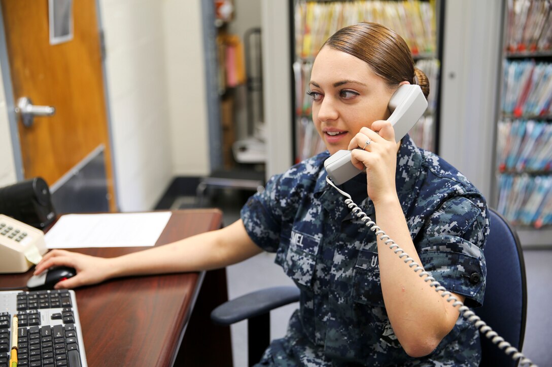 Seaman Jillian Zemel, a corpsman at the Marine Corps Air Station Beaufort Branch Medical Clinic, speaks on the phone with a patient, Oct. 1. 