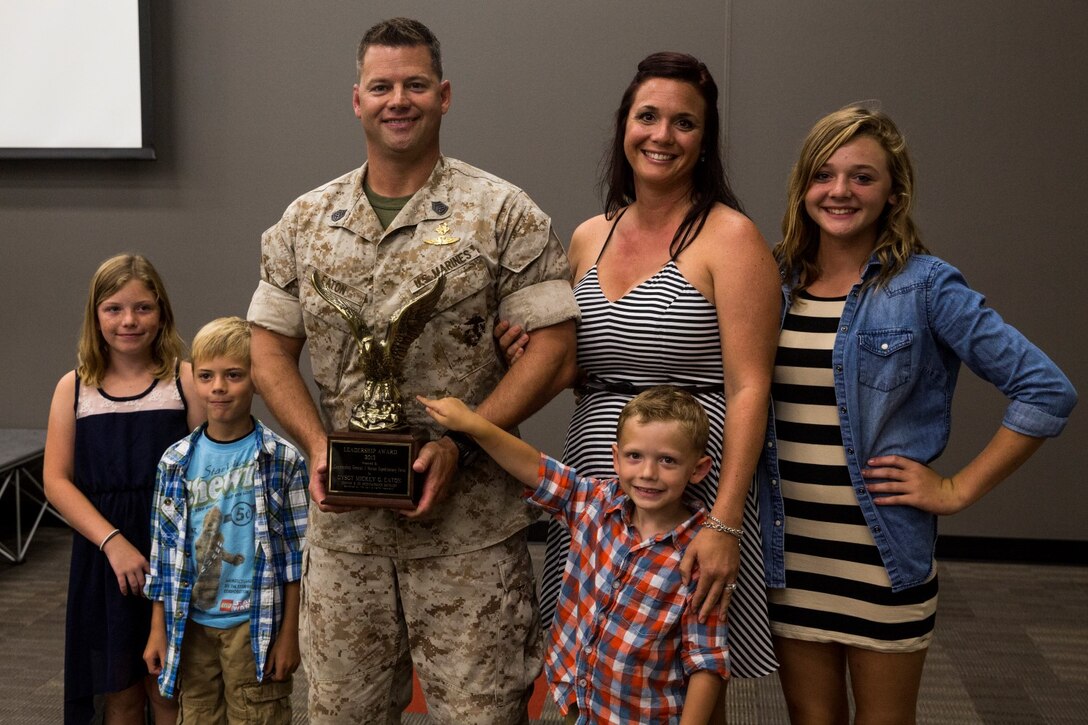 U.S. Marine Gunnery Sgt. Mickey Eaton poses with his family after receiving the Navy and Marine Corps Association Leadership Award aboard Camp Pendleton, Calif., Sept. 26, 2014. Eaton, from Chicago, Ill., is the assistant operations chief for Bravo Company, 1st Reconnaissance Battalion. (U.S. Marine Corps photo by Cpl. Anna Albrecht/Released)