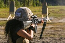 Ms. Maeva Saez, a Venezuela native, fires the M16 A4 service rifle during a Jane Wayne day aboard Camp Lejeune, N.C., Sept. 30, 2014. Jane Wayne day is designed to show spouses a few of the jobs their Marines perform and to strengthen the bond between unit and family.  (U.S. Marine Corps photo by Cpl. Michael Dye / Released)