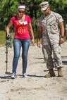 Master Sergeant Heriberto Purcell, the operations chief with Bravo Company, 8th Engineering Support Battalion, and Puerto Rico native, walks with his wife, Kathia Purcell, during an Improvised Explosive Device training lane during the 8th Engineering Support Battalion’s Jane Wayne day aboard Camp Lejeune, N.C., Sept. 30, 2014. Jane Wayne day is designed to show spouses a few of the jobs their Marines perform and to strengthen the bond between unit and family. (U.S. Marine Corps photo by Cpl. Michael Dye / Released)