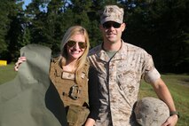Amber H. Crump poses with her husband Capt. Richard M. Crump, the battalion maintenance management officer for Headquarters and Support Company, 8th Engineer Support Battalion, after firing the M16A4 service rifle during the battalion’s Jane Wayne Day Sept. 30, 2014. The day involved activities like the live-fire range, a combat fitness test, and interactive vehicle displays, all with the purpose of showing the spouses what their Marines do. The Crumps are originally from Mobile, Ala. (Marine Corps photo by Lance Cpl. Michelle M. Reif / Released)