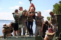 Marines and their spouses take a ride on a bridge erection boat together during the 8th Engineer Support Battalion’s Jane Wayne Day, Sept. 30, 2014. By doing activities that their Marine spouses do every day, the spouses were able to gain a deeper appreciation for their husband or wife and now have a better basis for understanding and communication in their relationship. (Marine Corps photo by Lance Cpl. Michelle M. Reif / Released)