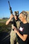 Lance Cpl. Andrew Lewis, a bulk fuel Marine with 8th Engineer Support Battalion and native of Kalamazoo, Mich., instructs his wife, Catherine Lewis, on how to fire an M16A4 service rifle during the battalions’ Jane Wayne Day, Sept. 30, 2014. By doing activities that their Marines do every day, spouses were able to gain a deeper appreciation for their husband or wife and now have a better basis for understanding and communication in their relationship. (Marine Corps photo by Lance Cpl. Michelle M. Reif / Released)