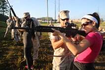 Master Sgt. Heriberto Purcell, operations chief of Company B, 8th Engineer Support Battalion and native of Puerto Rico, instructs his wife, Kathia M. Purcell on the proper way to hold an M16A4 service rifle during the battalion’s Jane Wayne Day, Sept. 30, 2014. By doing activities that their Marines do every day, spouses were able to gain a deeper appreciation for their husband or wife and now have a better basis for understanding and communication in their relationship. (Marine Corps photo by Lance Cpl. Michelle M. Reif / Released)