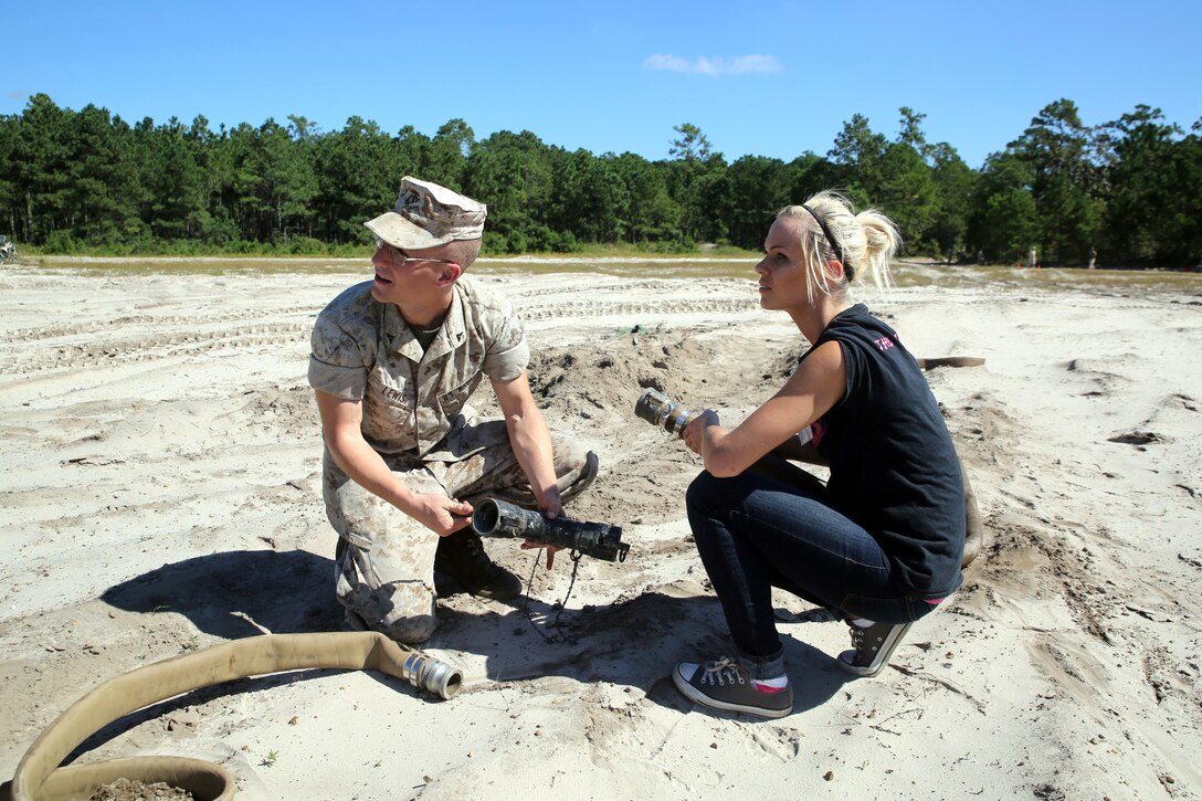 Lance Cpl. Andrew Lewis shows his wife, Catherine Lewis, what he does on a daily basis as a bulk fuel Marine for 8th Engineer Support Battalion during the battalion’s Jane Wayne Day, Sept. 30, 2014. By doing activities that their Marines do every day, spouses were able to gain a deeper appreciation for their husband or wife and now have a better basis for understanding and communication in their relationship. The Lewis’ are originally from Kalamazoo, Mich. (Marine Corps photo by Lance Cpl. Michelle M. Reif / Released)