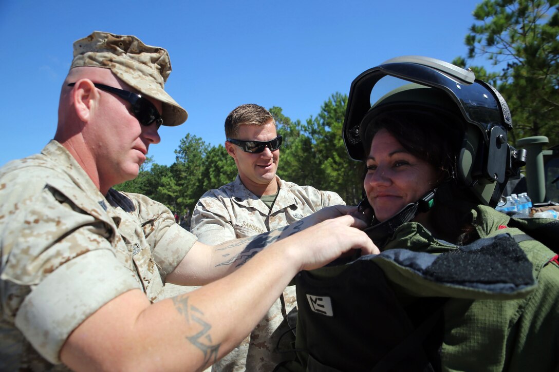 Melissa Smith, a native of Monterey, Calif., tries on the 80-pound bomb protection suit during the 8th Engineer Support Battalion’s Jane Wayne Day, Sept. 30, 2014. By doing activities that their Marines do every day, spouses were able to gain a deeper appreciation for their husband or wife and now have a better basis for understanding and communication in their relationship.  Melissa Smith’s husband is Staff Sgt. Ashley Smith, a Sport Company platoon sergeant for 8th ESB. (Marine Corps photo by Lance Cpl. Michelle M. Reif / Released)